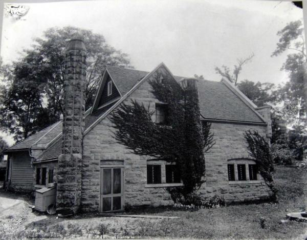 an old house with trees in the background