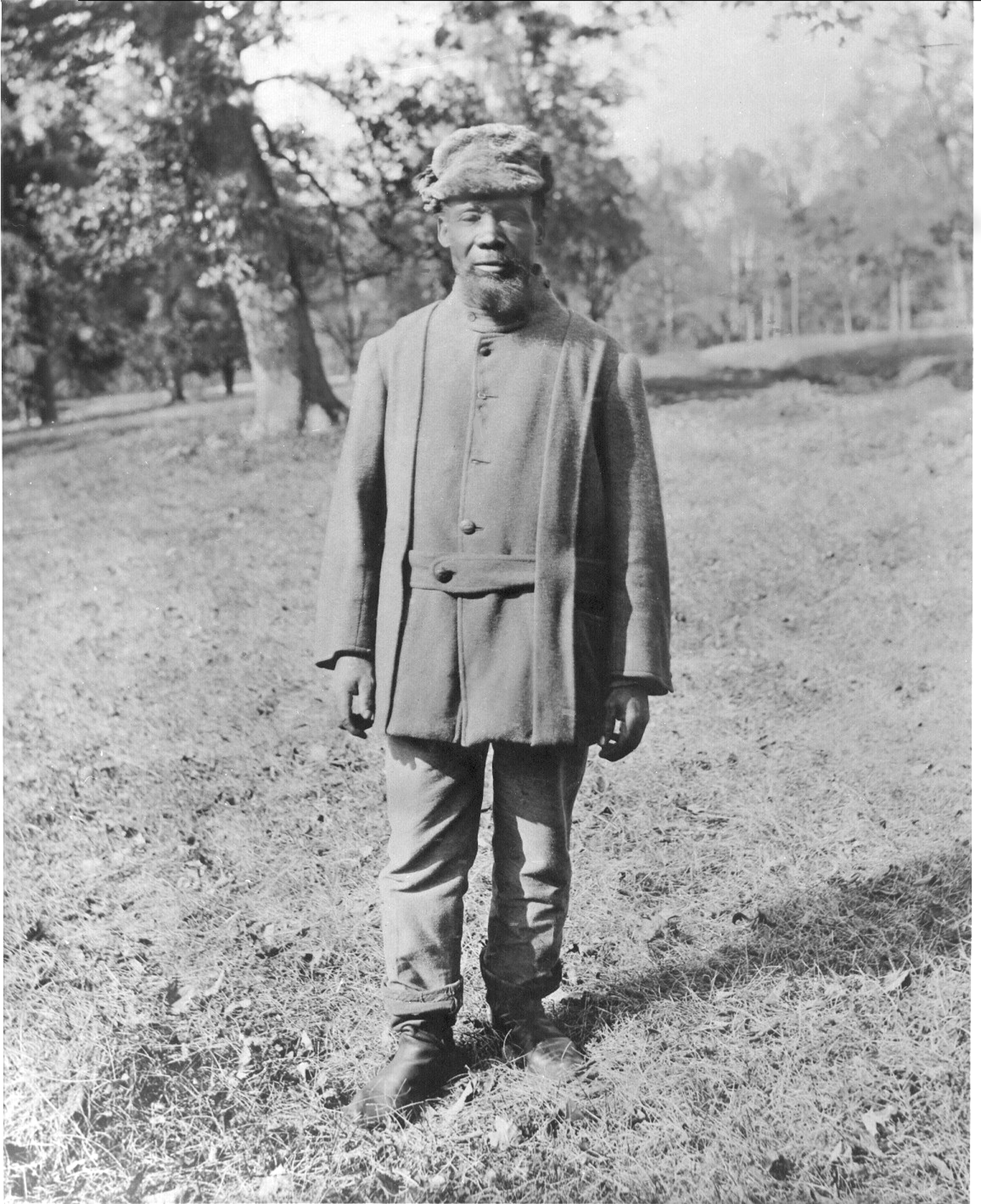 a man standing on top of a dirt field