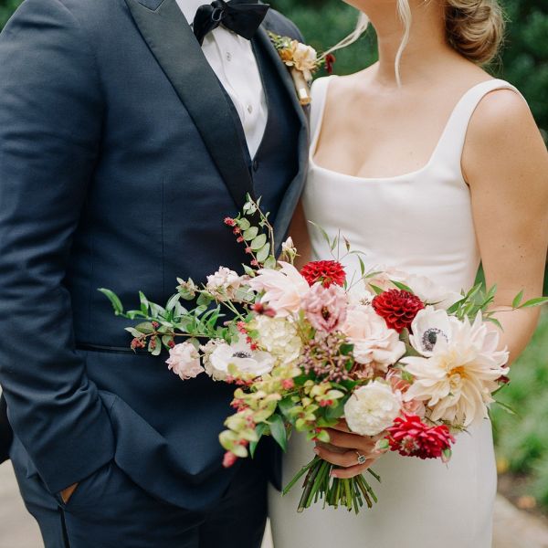 a woman standing in front of a flower