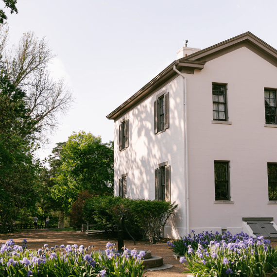 a large brick building with grass in front of a house