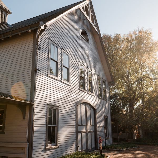 a large stone statue in front of a brick building