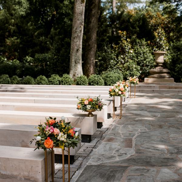 a vase of flowers sitting on a bench
