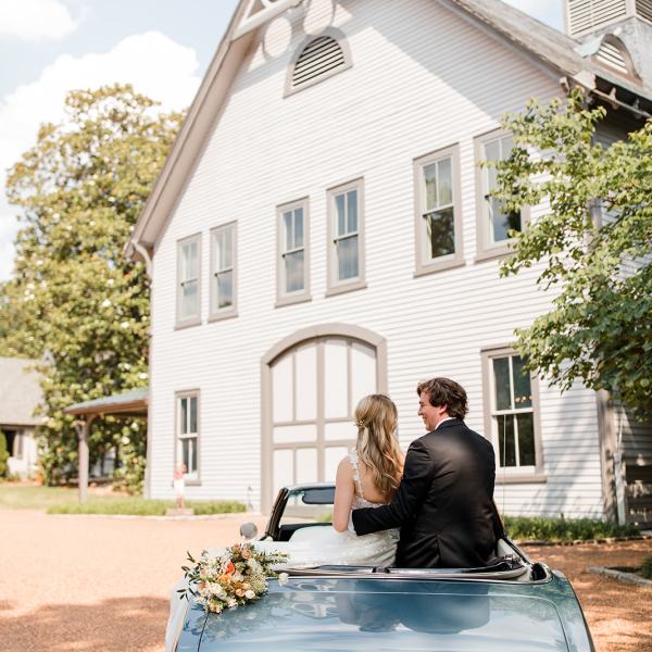 a man standing in front of a car