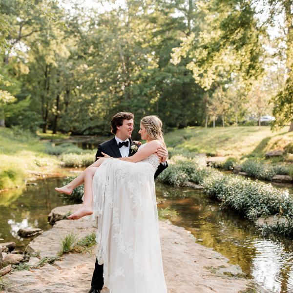 a man standing next to a river