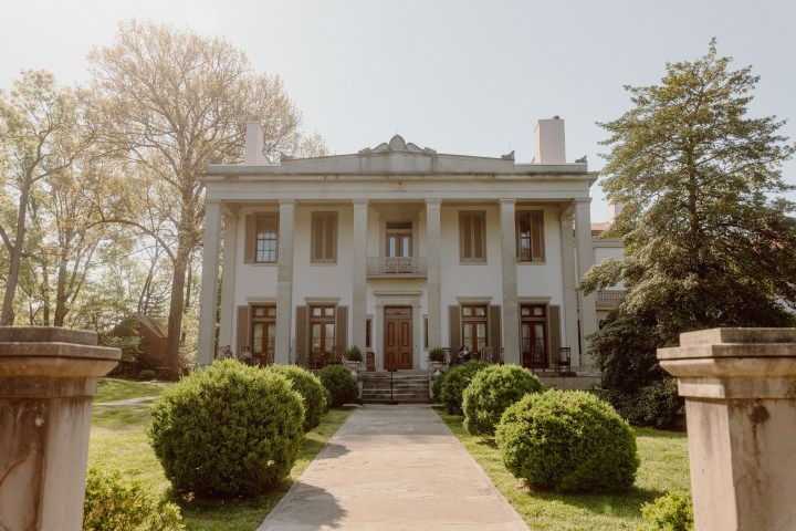 a large stone statue in front of a house